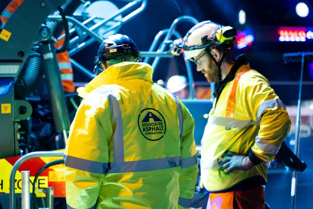 2 persons working - associated asphalt