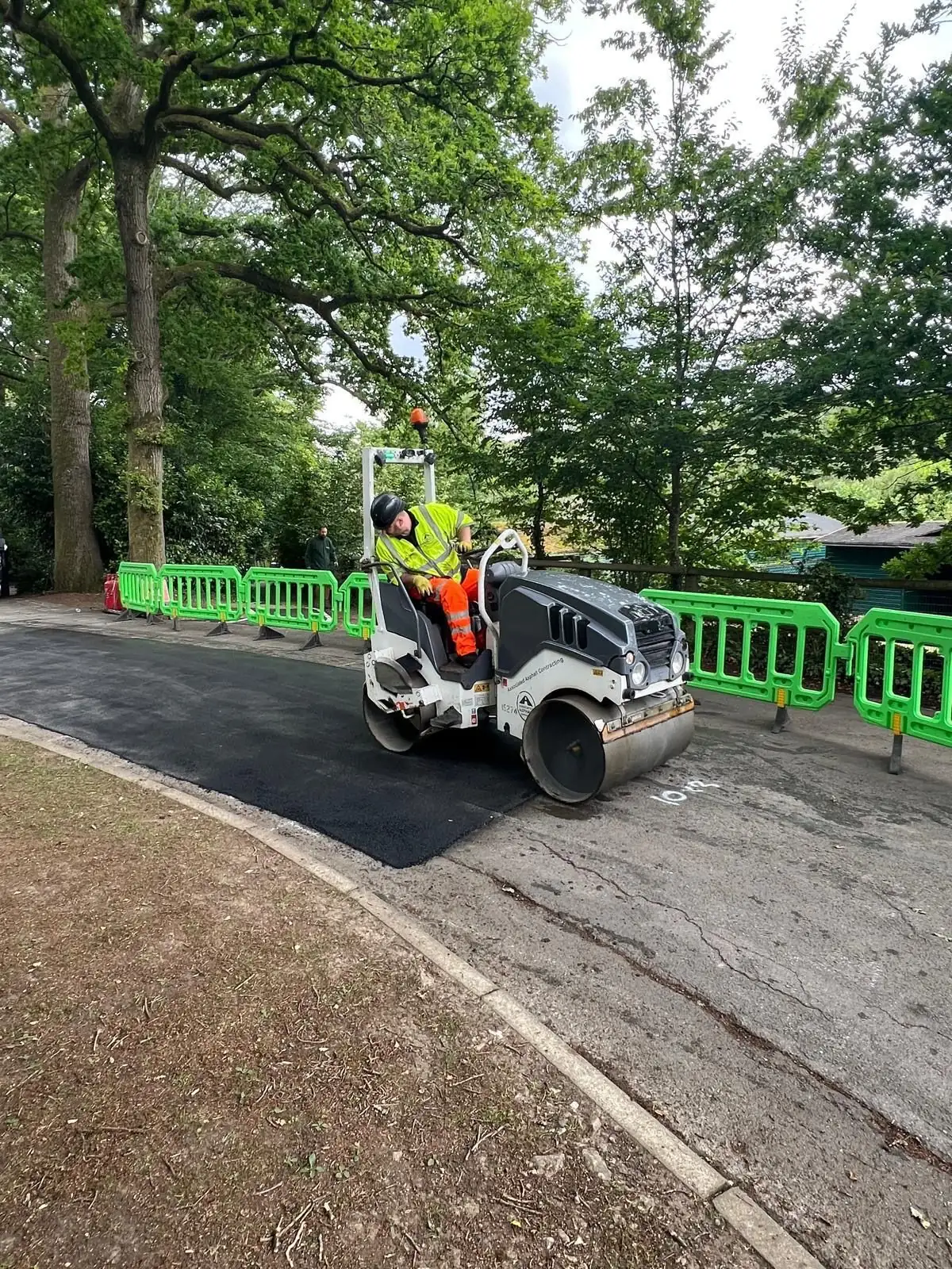 Operator Driving Ride-On Roller for Pedestrian Pathway Resurfacing