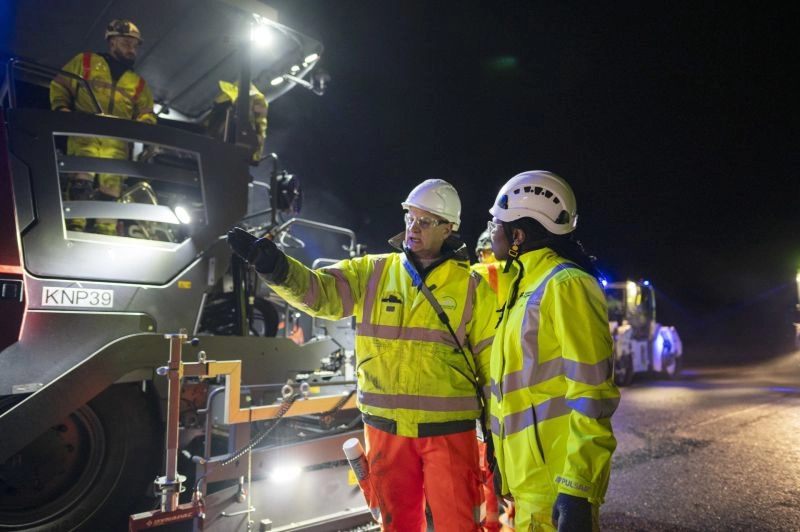Site Supervisors and Civil Engineers Discussing Roadworks Project at Night